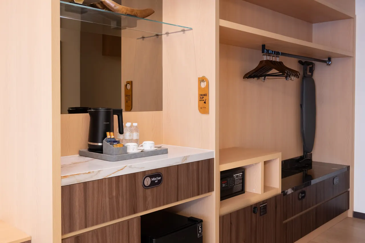 Timber dressing area and refreshment counter inside an Asteria Melaka suite.