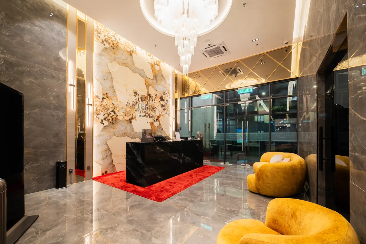 Asteria Melaka's marble arrival lobby beneath a sculptural chandelier.